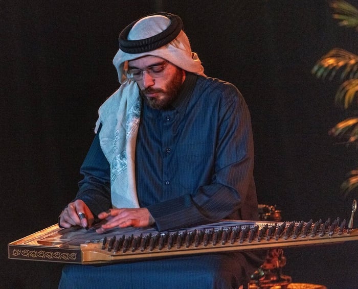 Dr. Mustafa Said performing oud with attentive listeners.