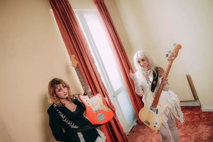 Lambrini Girls live on stage embodying punk spirit