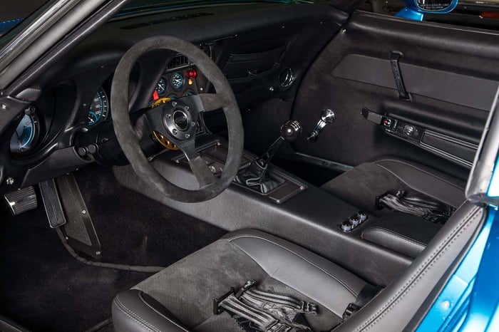 Interior shot featuring custom-wrapped Kirkey racing seats.