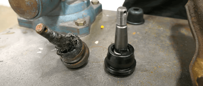 Close-up of worn ball joints replaced with Detroit Speed high-performance parts.