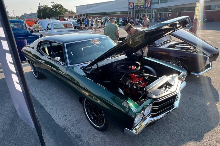 ront three-quarter view of the Audi Azores Green 1970 Chevrolet Chevelle with black SS stripes.