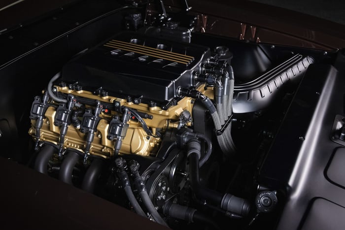 Engine bay of Kevin Hart’s GTO highlighting the supercharged LT5 crate engine with custom closeout panels and a fabricated cold-air intake routed through the front fender.