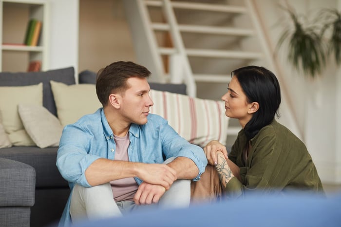 Husand talking to wife about gambling losses.