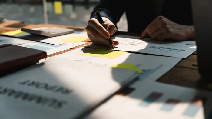 Close-up image of a person's hands holding a project management certification test