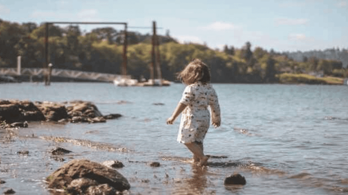 Girl Working By The Water