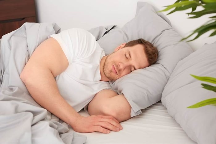 A person sleeping in bedAI-generated content may be incorrect.
