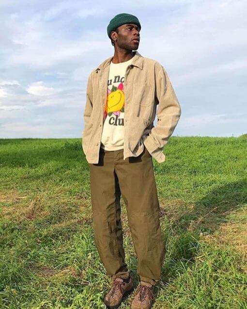 man wearing a beanie in a field