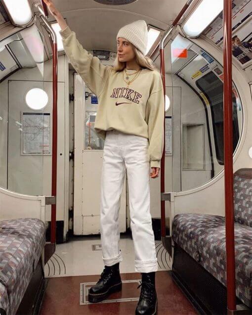woman wearing a beanie and sweatshirt on the subway