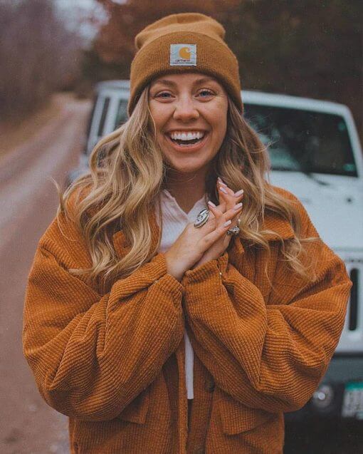 woman wearing a beanie and smiling