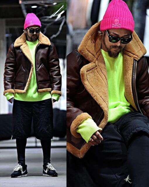 person wearing a bright pink beanie and neon sweatshirt