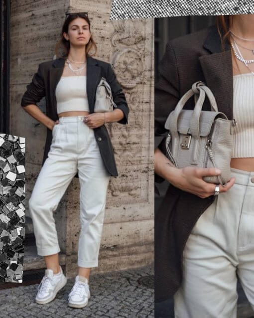 Woman wears a blazer over a white crop top.