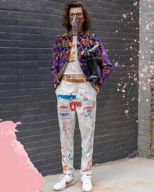 Man in New York poses in extravagant outfit with a crop top.