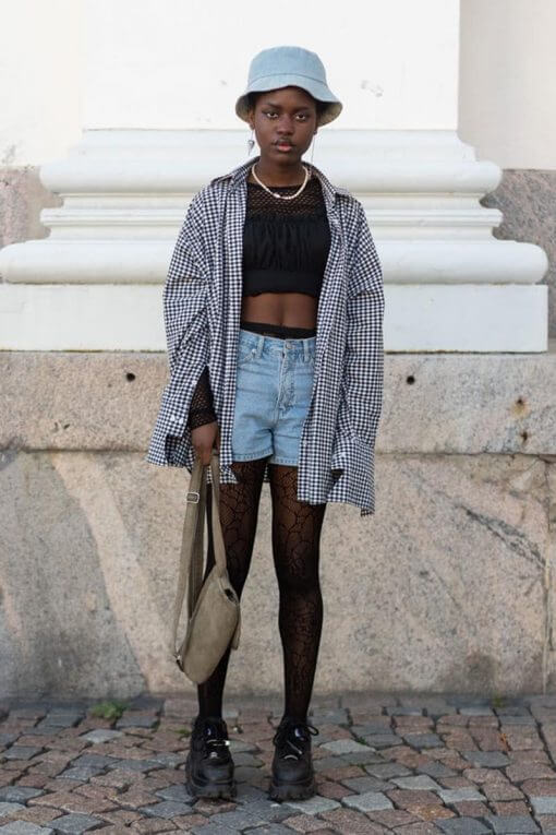 woman wearing vintage flannel shirt and bucket hat