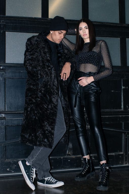 Standing man and woman wearing faux fur coat and rhinestones