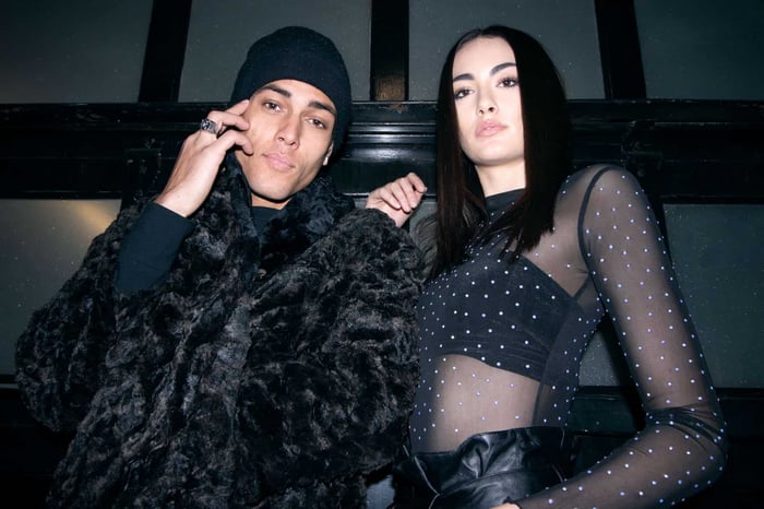 Man and woman wearing faux fur coat and rhinestones