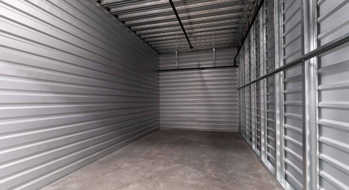 A small business owner organizes inventory in a clean, well-lit storage unit provided by STORAGExperts in Scottsdale, Arizona.