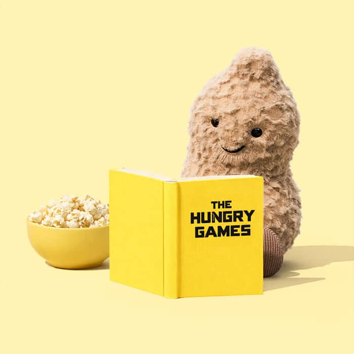 Amuseables Peanut reading The Hungry Games with popcorn on the side