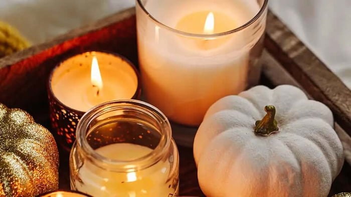 decorative autumn pumpkins and lit candles