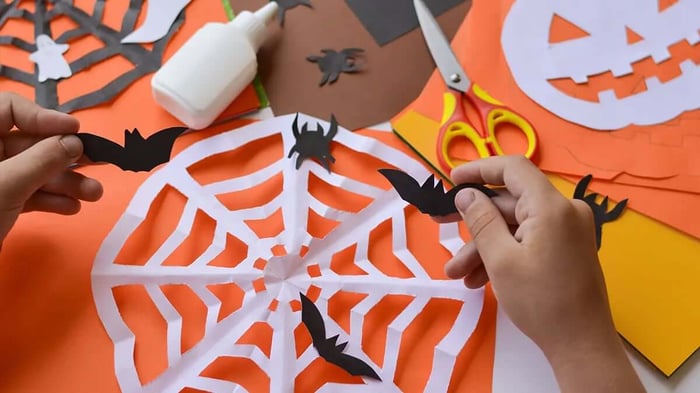 a child doing DIY Halloween decorations