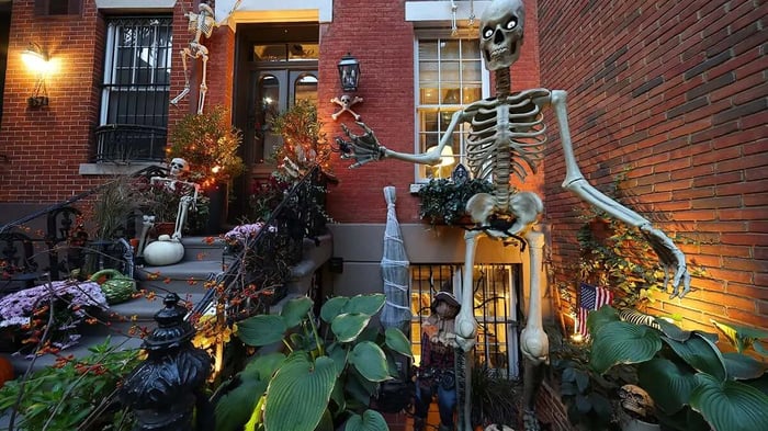 a house with a garden filled with Halloween decorations