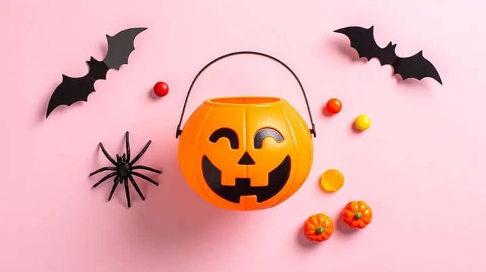 a plastic Halloween bucket surrounded by other Halloween decorations