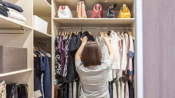 a woman organizing her closet to swap for the season