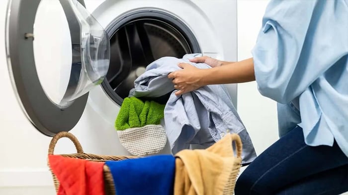 a woman washing clothes for storage