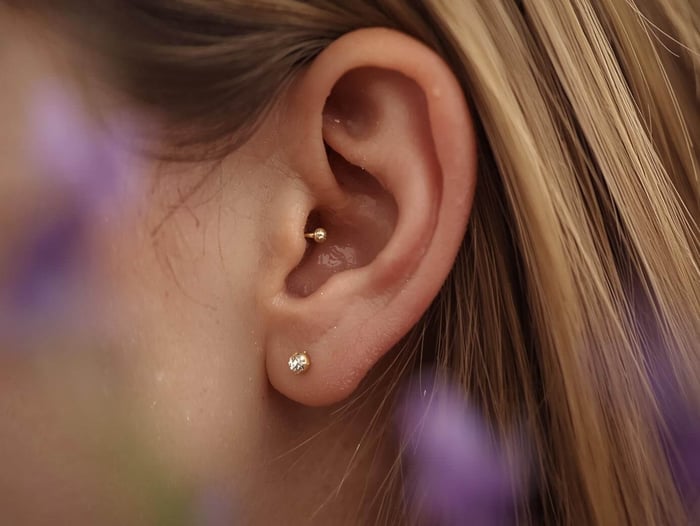 Close up of ear with tragus piercing for migraines