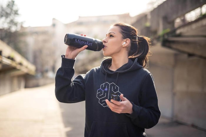 Person taking Brain Ritual® supplement for the dietary management of migraine