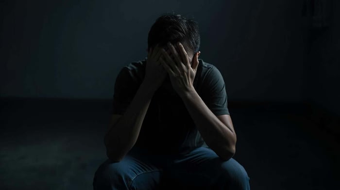 Person holding eye and forehead during migraine episode