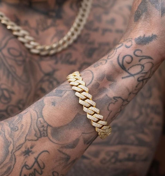 Iced 18k gold bracelet with chain on man with tattoos