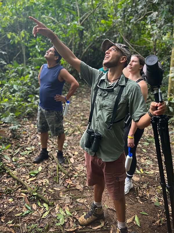 Isaac points out a sighting on a tour with the Latin Routes team