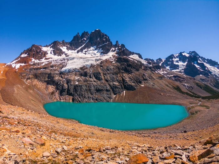 Cerro Castillo mountains rising above a turquoise glacial lake in Chilean Patagonia