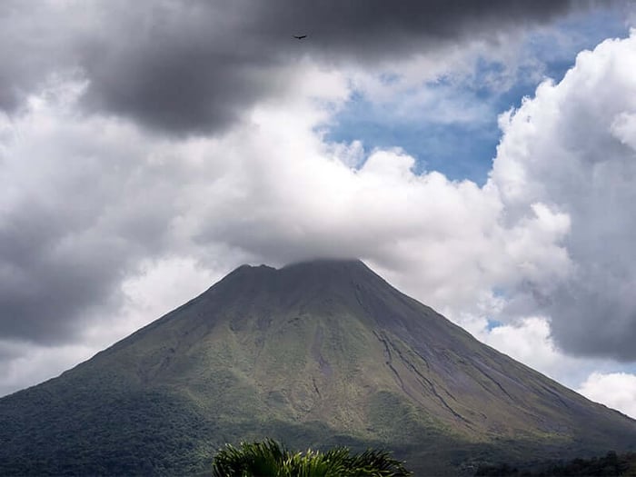 Atmospheric Arenal shrouded in clouds