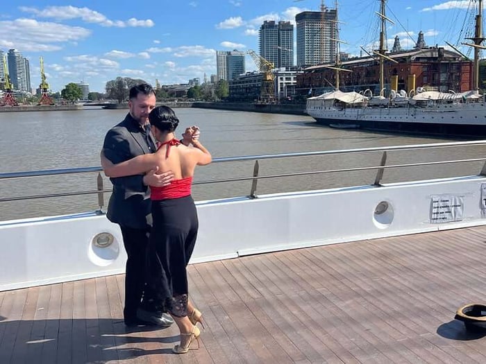 A couple dancing tango on a bridge in Buenos Aires