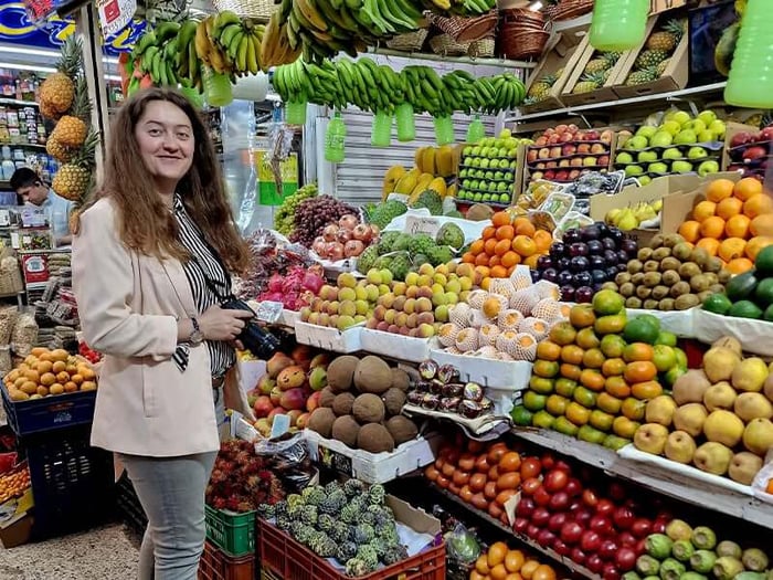 Mihaela sampling exotic fruits at Paloquemao Market in Bogotá