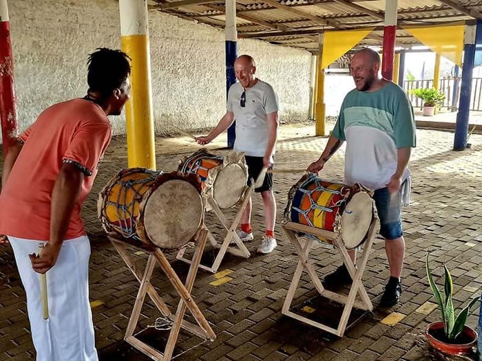 Oliver and Paul having lots of fun learning to play drums at Kilele Son