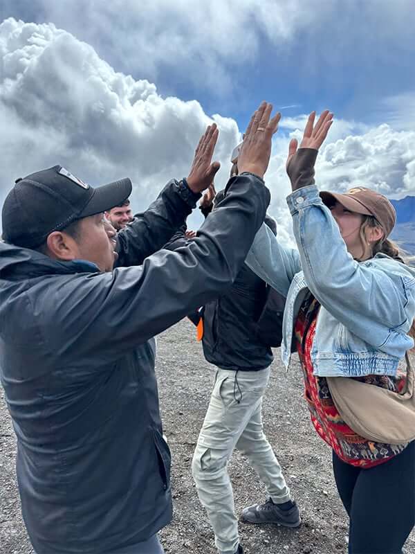 High fives in lots of layers at the Cotopaxi summit
