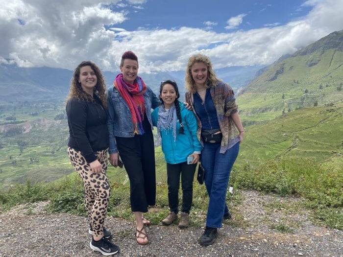 Nicole, Georgia, and Milly with their guide backdropped by Colca Canyon