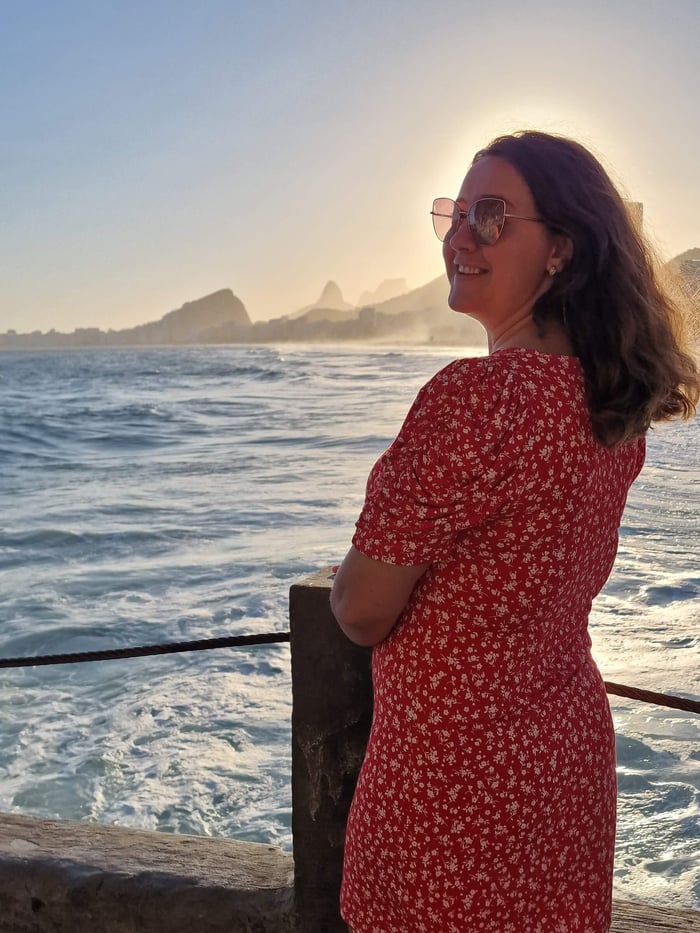 Mihaela enjoying the sunset across the water in Rio