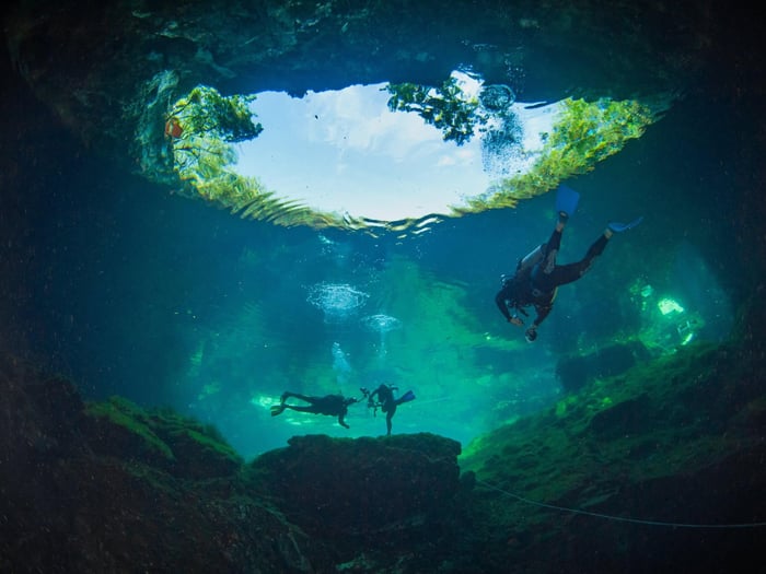Some people is swimming and snorkeling on Gran Cenote Yucatan