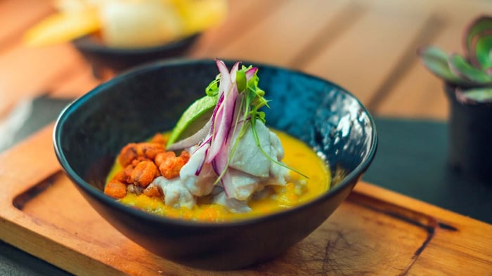 Plate of fresh Ceviche, bowl type with spices, unique dish and restaurant specialty, served at a table in front of the beach Guanacaste Costa Rica