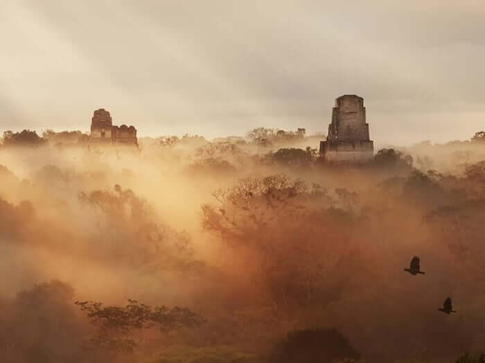 A misty sunrise at Tikal ruins