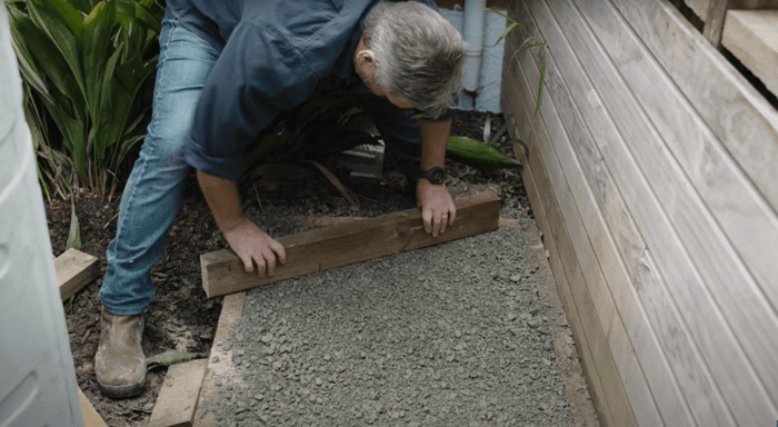 peter ensures the base is flat and compacted to support the slimline tank 