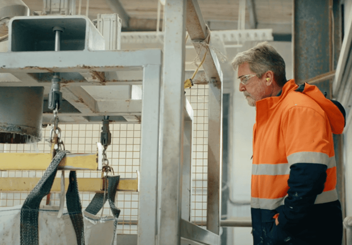 Peter overlooks a pallet of recycling material