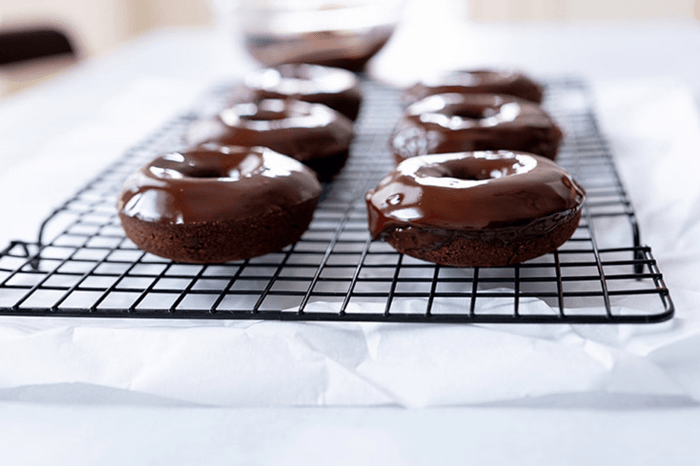 Finished Healthy Chocolate Donuts on a cooling rack.