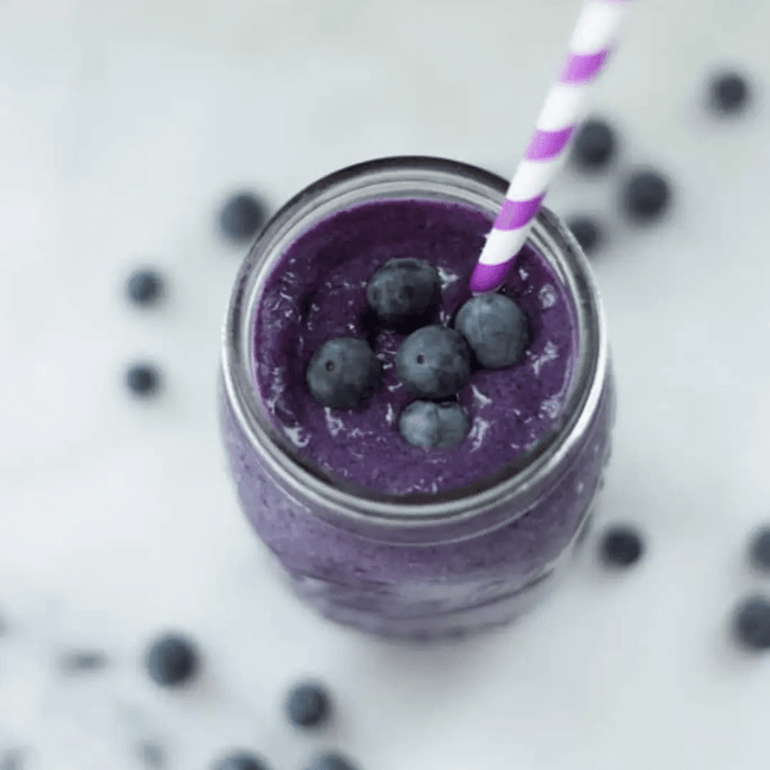 A photo of Fit + Slim Smoothie plated with blueberries in the background