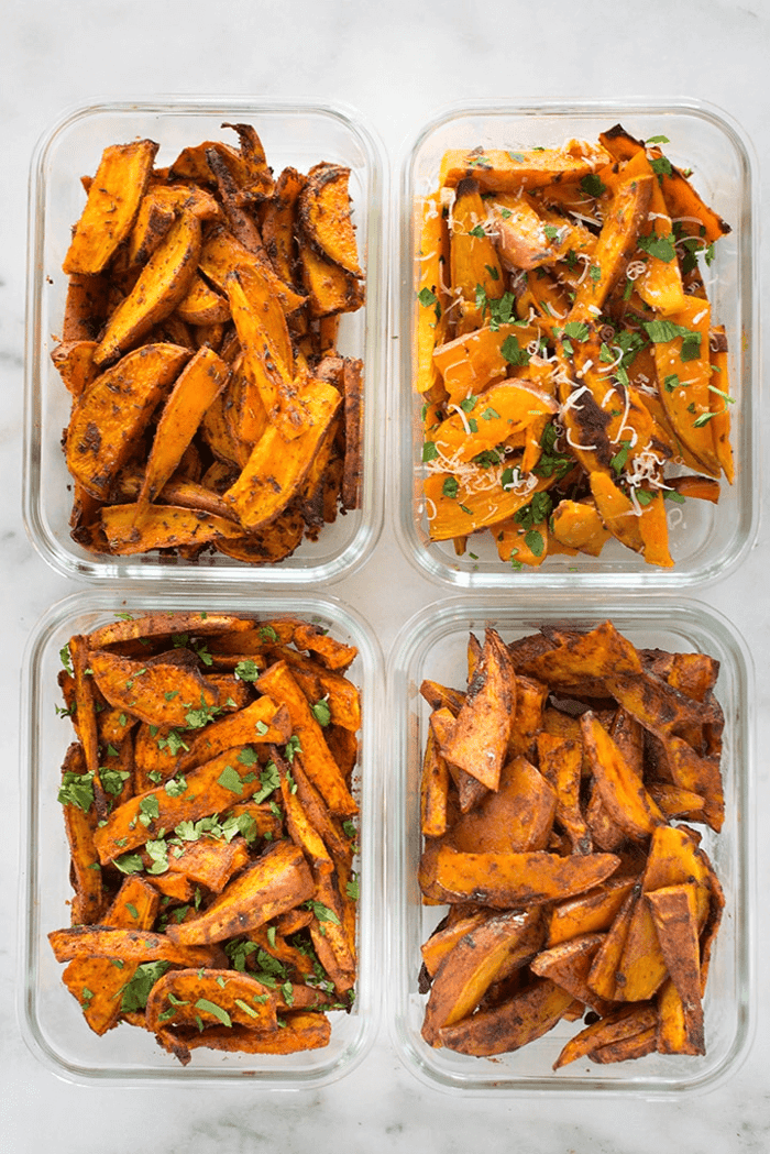 A photo of four meal prep containers all filled with different types of sweet potatoes fries for easy sweet potato fries meal prep.