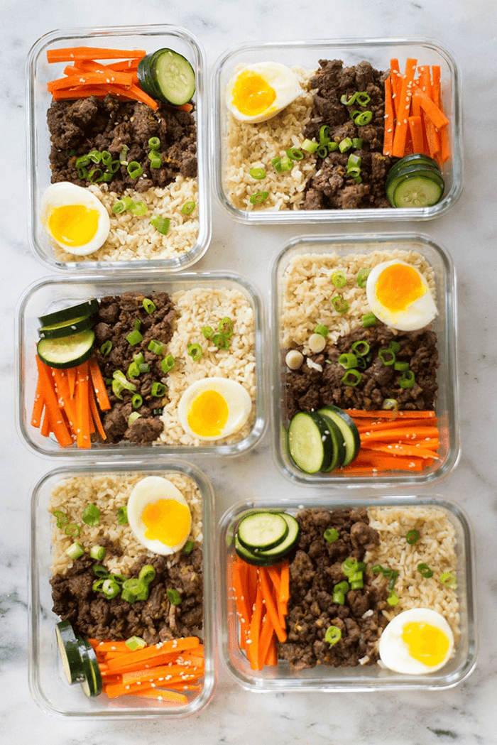 A photo of six meal prep containers full of korean beef bowl.