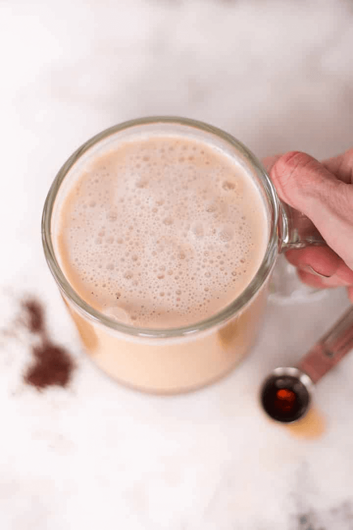 A photo of a clear glass mug full of a Healthy Vanilla Latte Recipe.